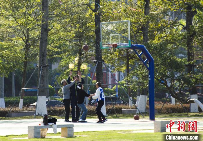 圖為市民、游客在防城港市公園廣場打籃球。　翟李強(qiáng) 攝